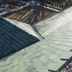 Closeup of green tiles on a roof.
