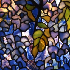 Closeup of mosaic wisteria with light shining through.